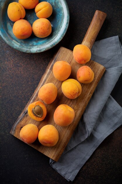 Delicious ripe apricots on a wooden stand