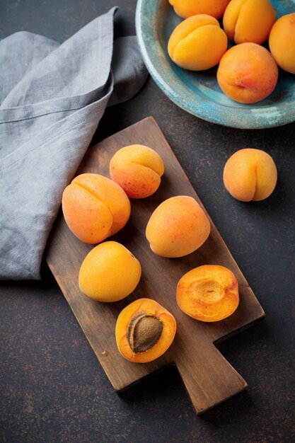 Delicious ripe apricots on a wooden stand