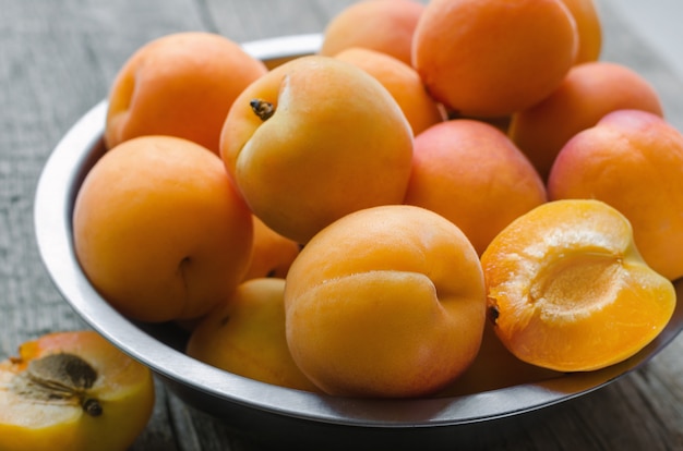 Delicious ripe apricots on wooden
