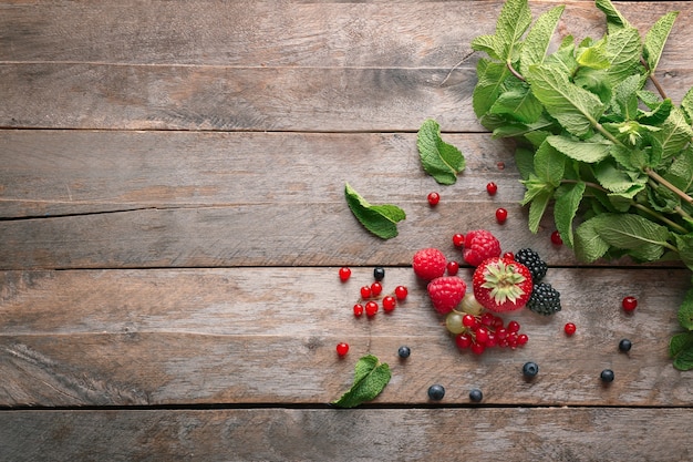 Delicious ripe berries on wooden surface