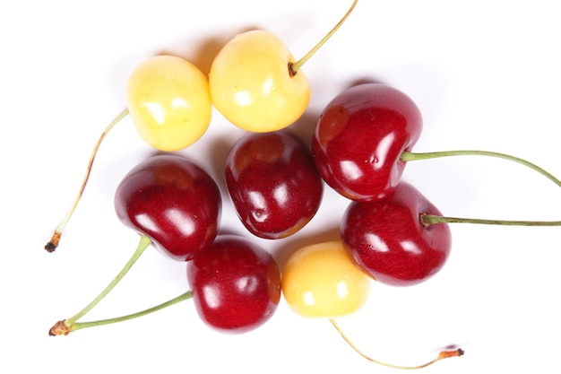 Delicious ripe cherries close up. Sweet cherry berry isolated on white background. Top view