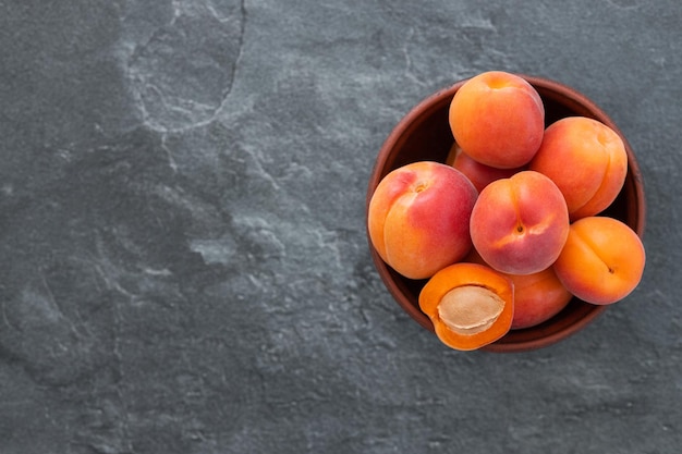 Delicious ripe sweet apricots on dark background