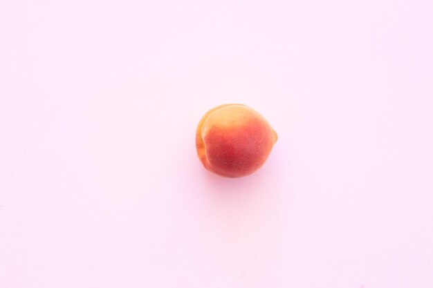 Delicious ripe sweet apricots on pink background flat lay