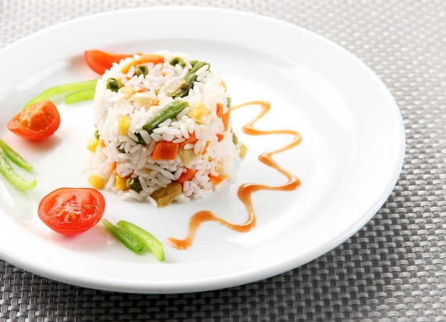 Delicious risotto with vegetables on table