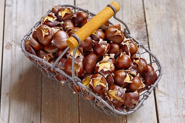 Delicious roasted chestnuts in a wire basket