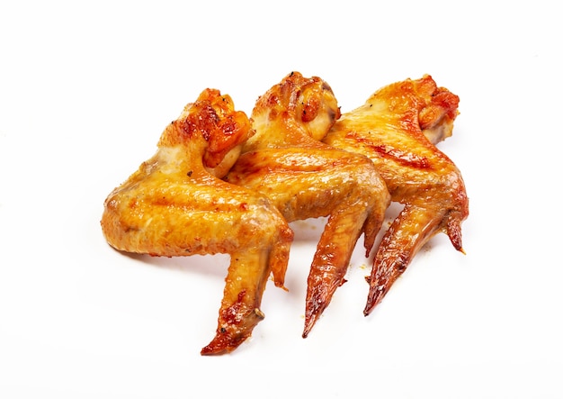 Delicious roasted chicken wings on white background
