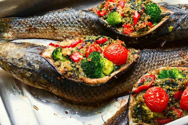Delicious roasted fish stuffed with broccoli,quinoa and tomato
