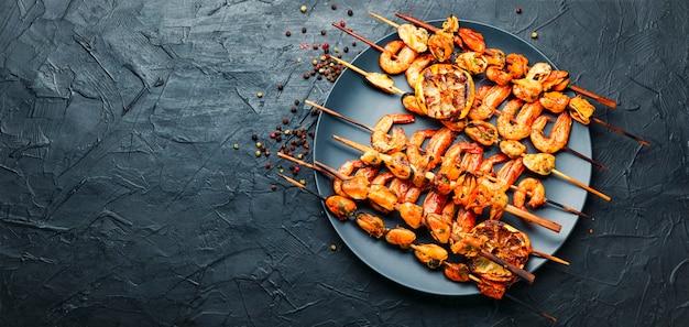 Delicious roasted shrimps and mussels on wooden skewers