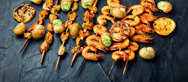 Delicious roasted shrimps and mussels on wooden skewers