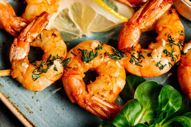 Delicious roasted shrimps on plate with lemon