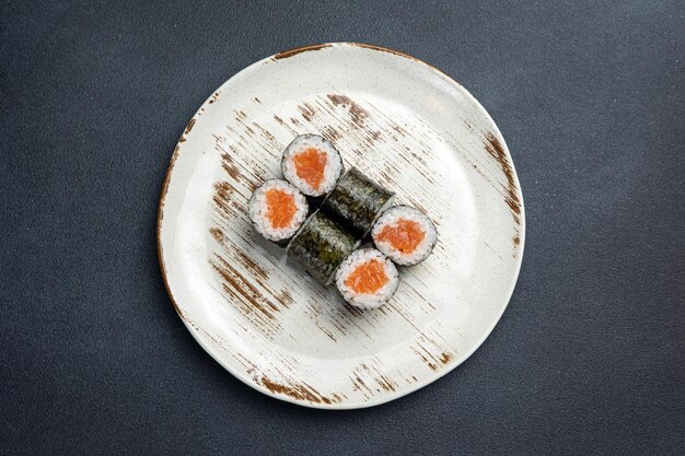 Delicious roll with salmon Japanese cuisine Black background Close up