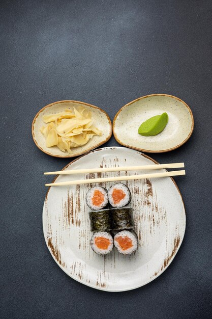 Delicious roll with salmon Japanese cuisine Black background Close up