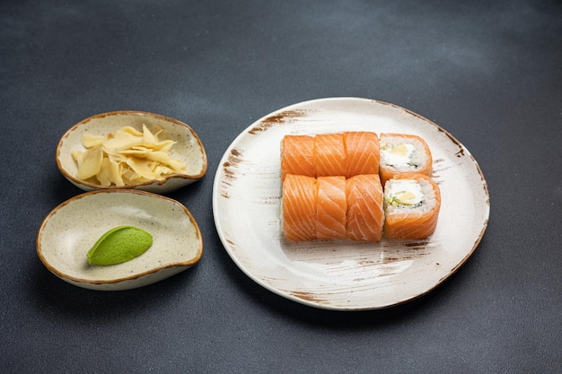 Delicious roll with salmon Japanese cuisine Black background Close up