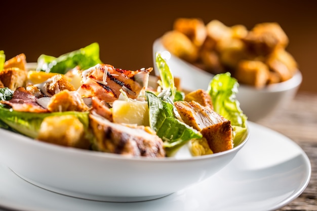 Delicious salad caesar with grilled chicken breast croutons eggs bacon and parmesan cheese