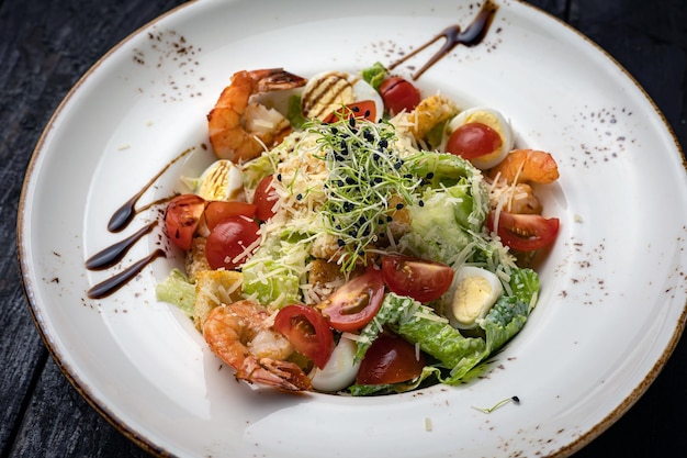 delicious salad in a plate on a dark table