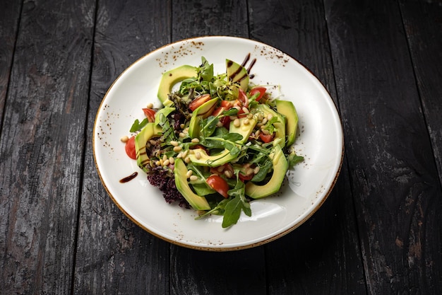 delicious salad in a plate on a dark table