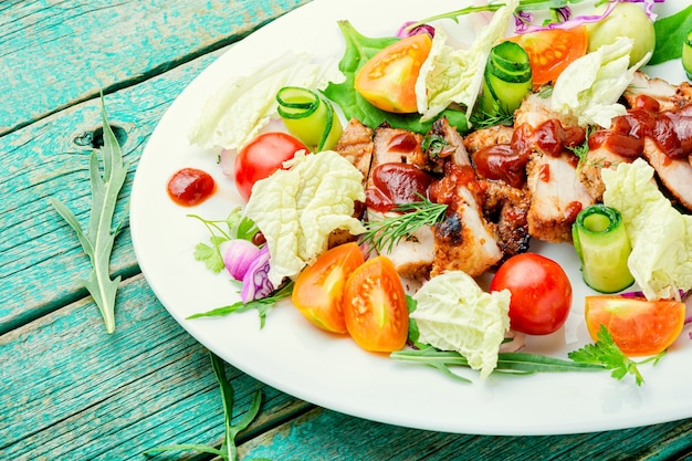 Delicious salad with tomato,cucumber,lettuce and meat steak.Healthy salad on white plate