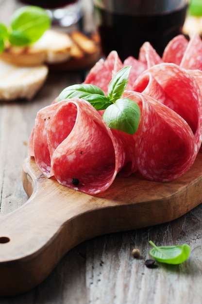 Delicious salami with basil and wine