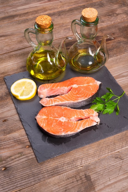 Delicious salmon steak on wooden table, close-up