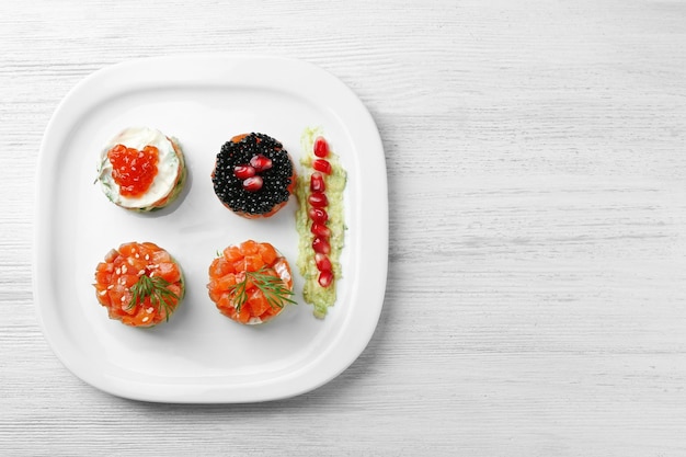 Delicious salmon tartare on white plate