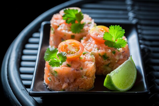 Delicious salmon tartare with lime and cherry tomatoes