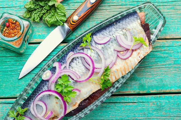 Delicious salted herring with red onion and pepper