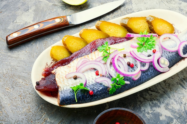 Delicious salted herring with red onion and pepper