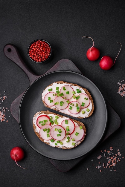 Delicious sandwich or bruschetta with cream cheese radish and green onions