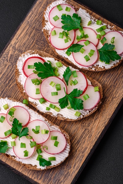 Delicious sandwich or bruschetta with cream cheese radish and green onions