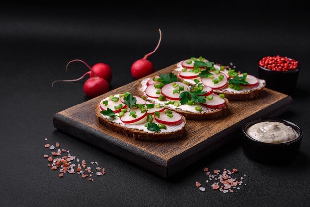 Delicious sandwich or bruschetta with cream cheese radish and green onions