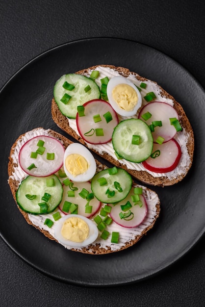 Delicious sandwich or bruschetta with cream cheese radish and green onions