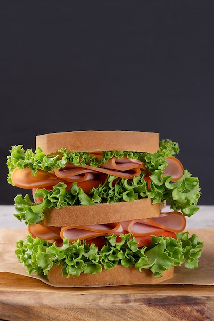 Delicious sandwich of ham, lettuce and tomato.