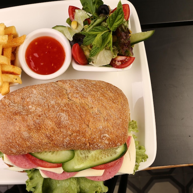 Delicious sandwich with french fries, breakfast meal.