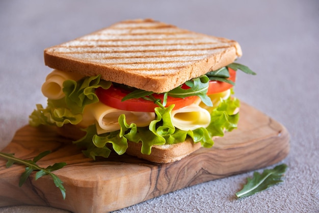 Delicious sandwich with toasted bread lettuce cheese and tomatoes Healthy homemade snack