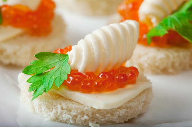 Delicious sandwiches with caviar closeup