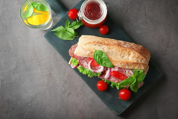 Delicious sausage sandwich on wooden board