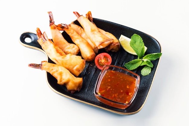 Delicious sauteed shrimp withsauce in bowl on white surface. Breaded Shrimps. Top view.