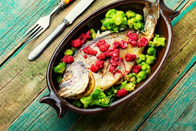 Delicious sea bream baked with raspberries and broccoli