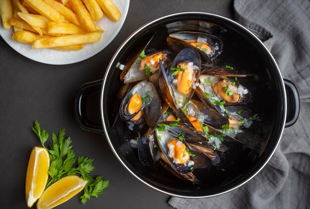 Delicious seafood mussels with parsley sauce and lemon. Delicious steamed mussels.