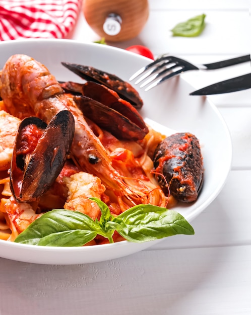 Delicious seafood pasta in tomato sauce with shrimps and mussels
