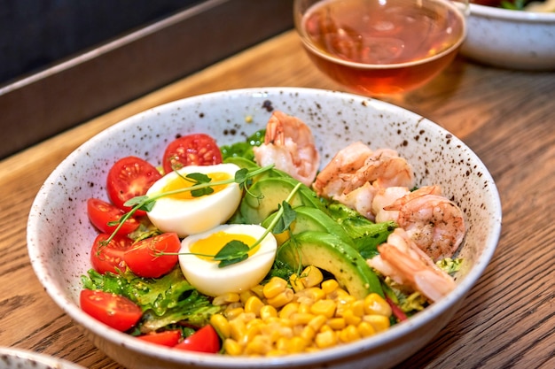 Delicious shrimp in restaurant on a wooden table. Tasty seafood with beer in cafe or pub menu.