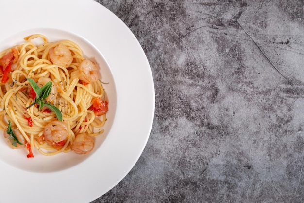 Delicious shrimp spaghetti on a cement table