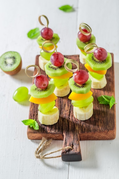 Delicious skewers with various fruits and mint for snack