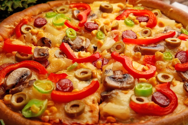 Delicious sliced pizza with vegetables closeup
