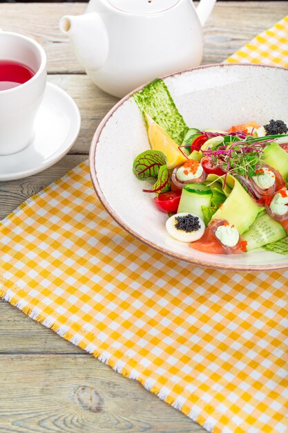 A delicious smoked salmon with salad 