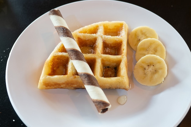 Delicious snack baked waffles served with chocolate stick