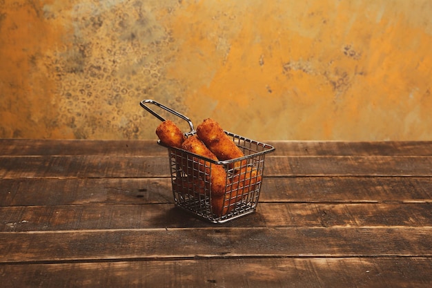 Delicious snack plate french fries onion rings spring rolls or sausages on the table