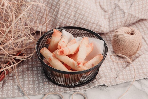 Delicious snack plate, french fries, onion rings, spring rolls\
or sausages on the table