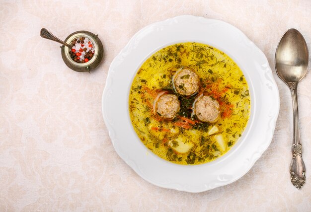 Delicious soup with chicken or Turkey meatballs with vegetables - potatoes, carrots, dill, parsley 