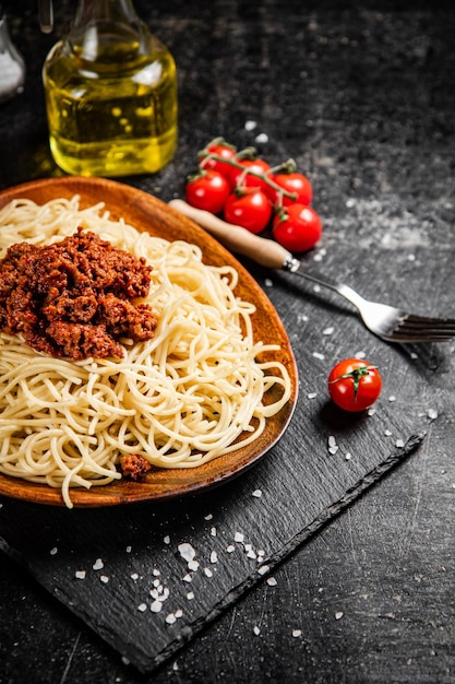 Delicious spaghetti bolognese in a bowl with cherry tomatoes